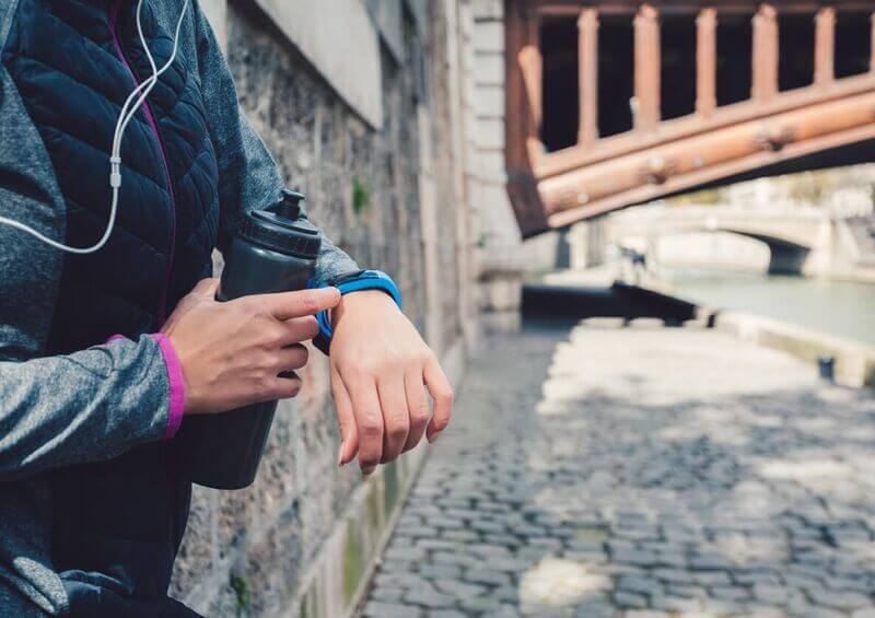 Person checking activity tracker after a run